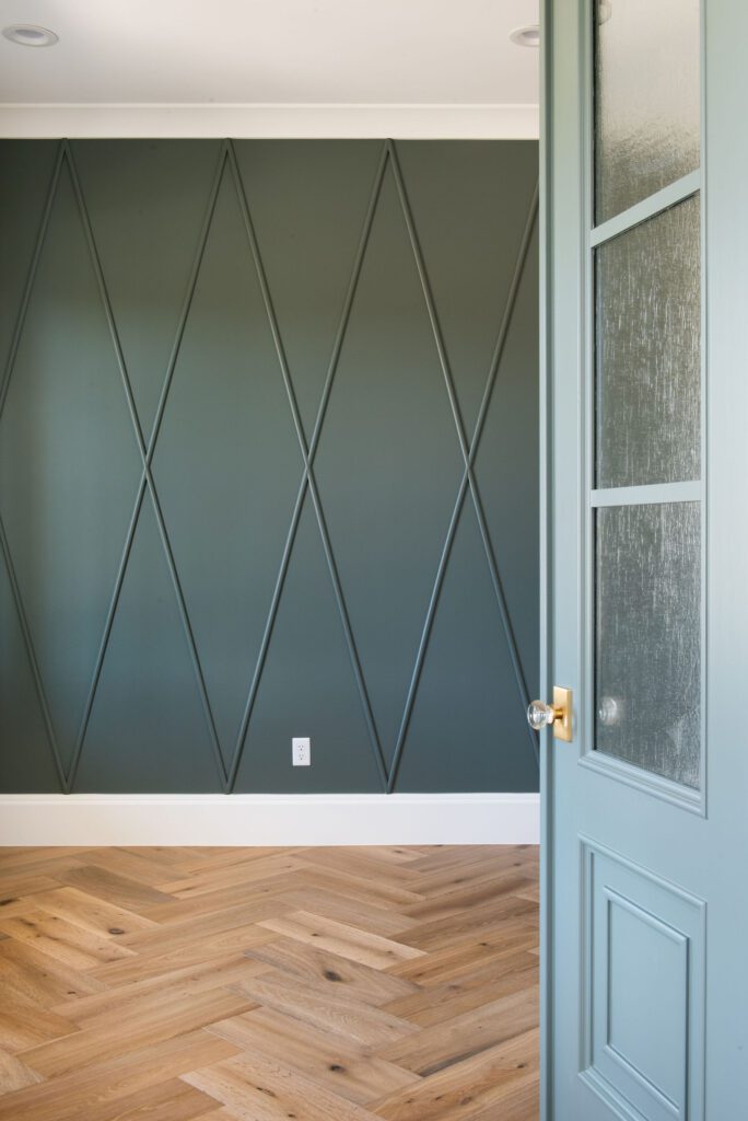 Room featuring a teal millwork wall 